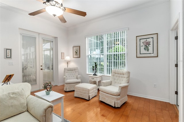 living room with ceiling fan, wood-type flooring, and a healthy amount of sunlight