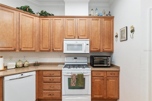 kitchen featuring ornamental molding, white appliances, and light stone countertops