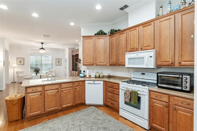 kitchen featuring ornamental molding, kitchen peninsula, white appliances, and ceiling fan