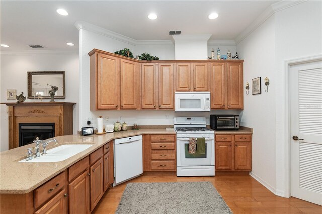 kitchen featuring light wood-type flooring, sink, kitchen peninsula, white appliances, and ornamental molding