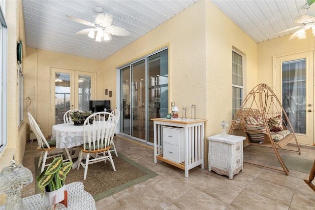 sunroom / solarium featuring wood ceiling, ceiling fan, and french doors