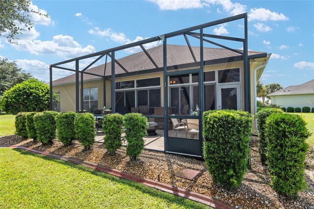 back of property featuring a yard and a lanai