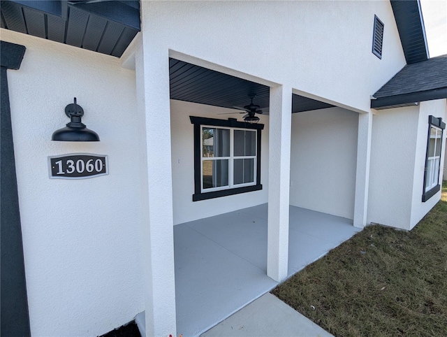 doorway to property featuring ceiling fan