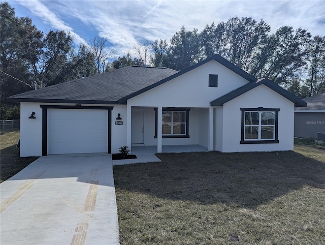 single story home featuring a front yard, a porch, and a garage