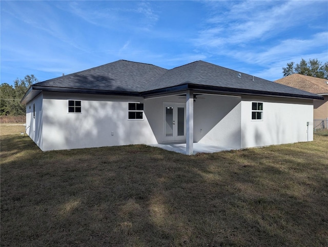 back of house with a yard and french doors