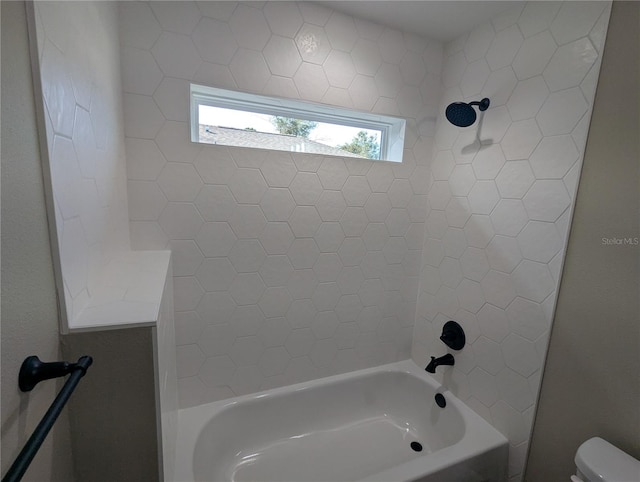 bathroom with toilet and bathing tub / shower combination