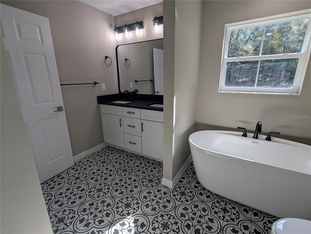 bathroom with tile patterned floors, vanity, and a bath