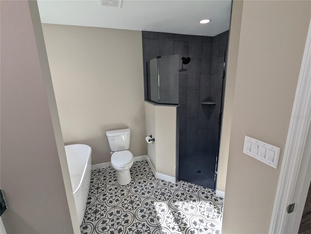 bathroom featuring separate shower and tub, tile patterned floors, and toilet