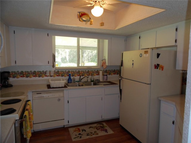 kitchen featuring dark wood-type flooring, sink, white cabinetry, white appliances, and ceiling fan