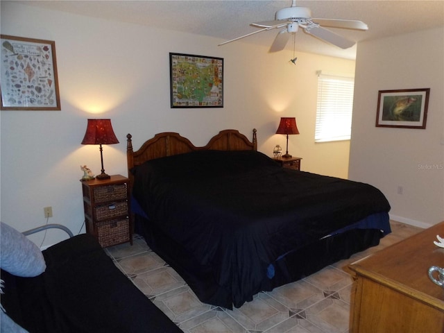 bedroom with ceiling fan and light tile patterned flooring