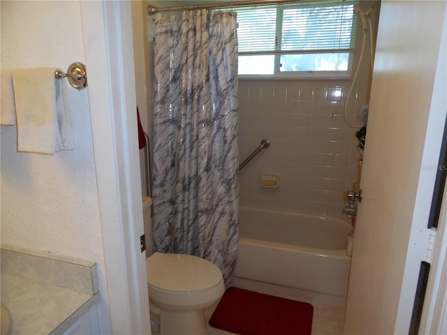 full bathroom with shower / tub combo with curtain, tile patterned flooring, vanity, and toilet