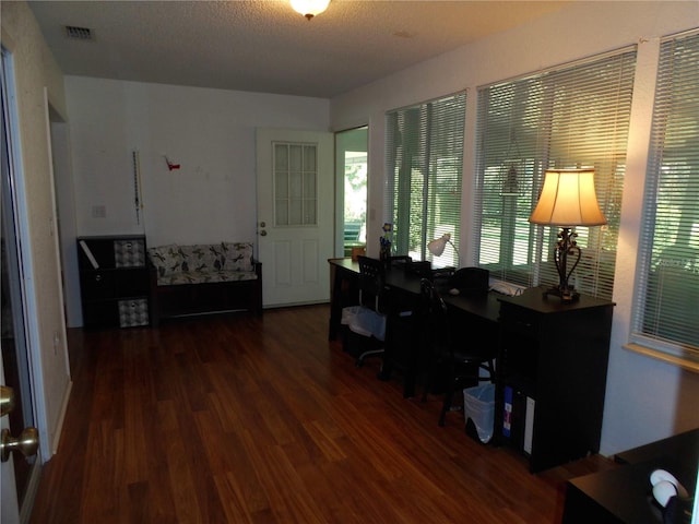 home office featuring a textured ceiling and dark hardwood / wood-style flooring