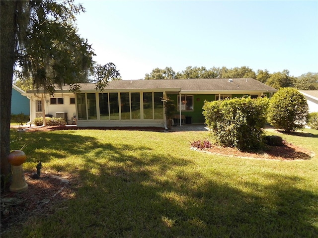 rear view of house with a lawn