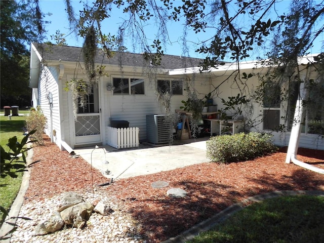 back of house with central AC unit and a patio