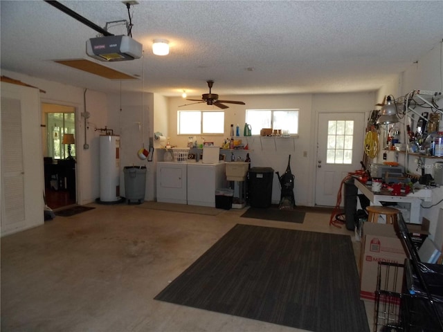 garage featuring ceiling fan, electric water heater, a garage door opener, and washer and dryer