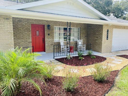 exterior space with covered porch and a garage