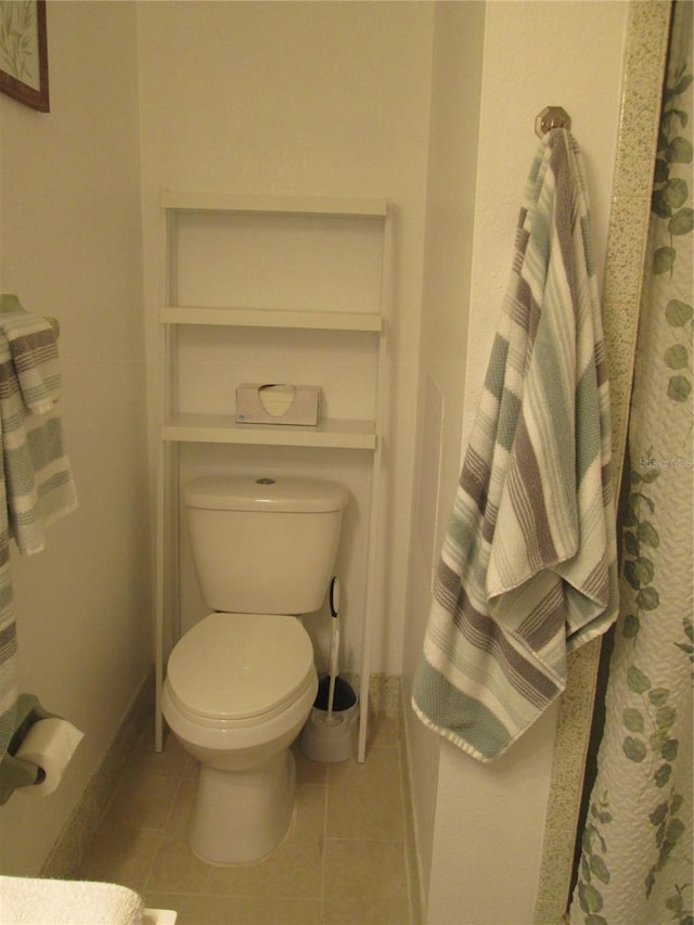 bathroom with tile patterned flooring and toilet