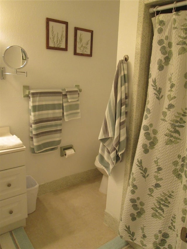 bathroom featuring walk in shower, vanity, and toilet