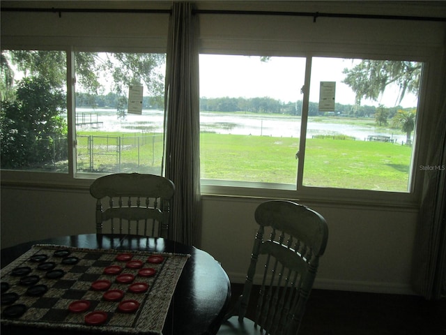 dining space with a water view and plenty of natural light