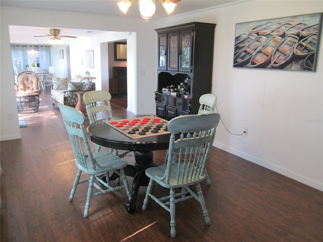 dining space with dark hardwood / wood-style flooring and ceiling fan