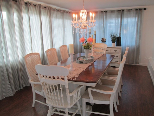 dining space with a chandelier and dark hardwood / wood-style flooring