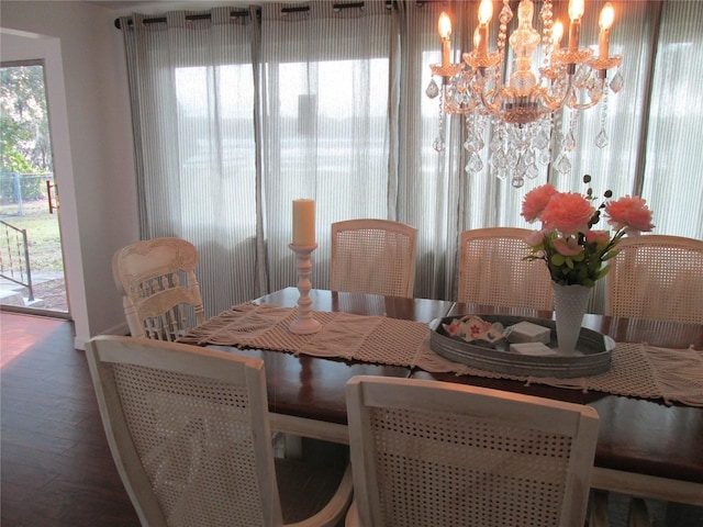 dining area featuring a notable chandelier and wood-type flooring