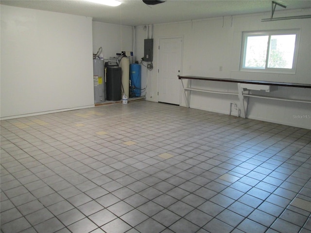 garage with ceiling fan, electric panel, a garage door opener, and water heater