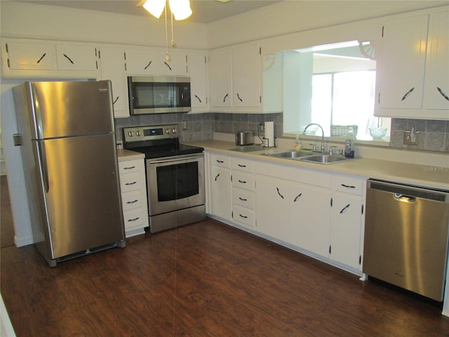 kitchen with appliances with stainless steel finishes, dark hardwood / wood-style floors, ceiling fan, and white cabinets