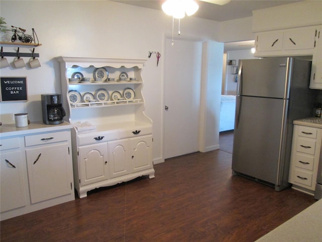 kitchen featuring dark hardwood / wood-style flooring, white cabinetry, and stainless steel refrigerator