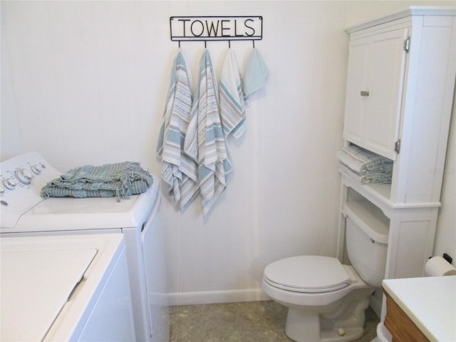 bathroom featuring vanity, washer and clothes dryer, and toilet