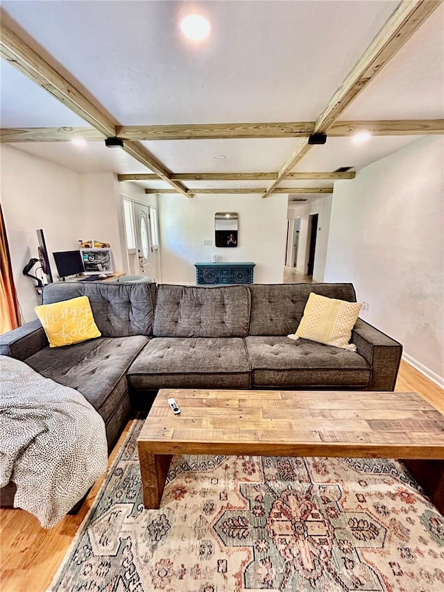 living room with beamed ceiling and wood-type flooring