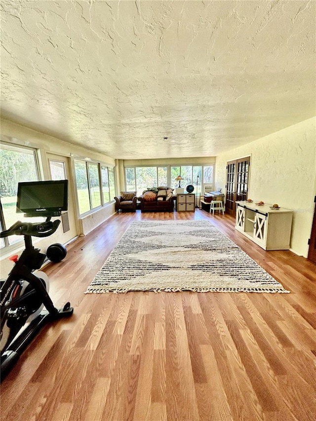 interior space with hardwood / wood-style flooring, plenty of natural light, and a textured ceiling