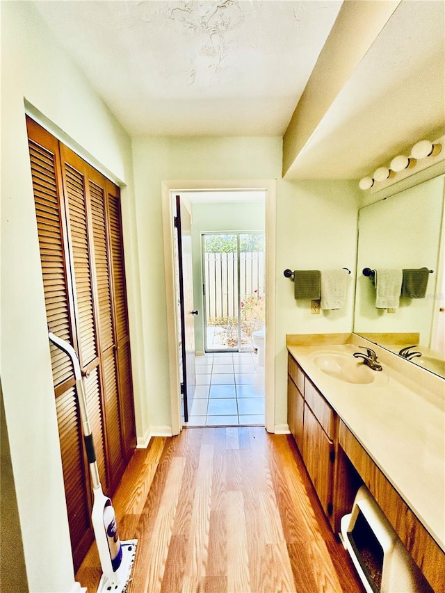 bathroom featuring hardwood / wood-style flooring and vanity