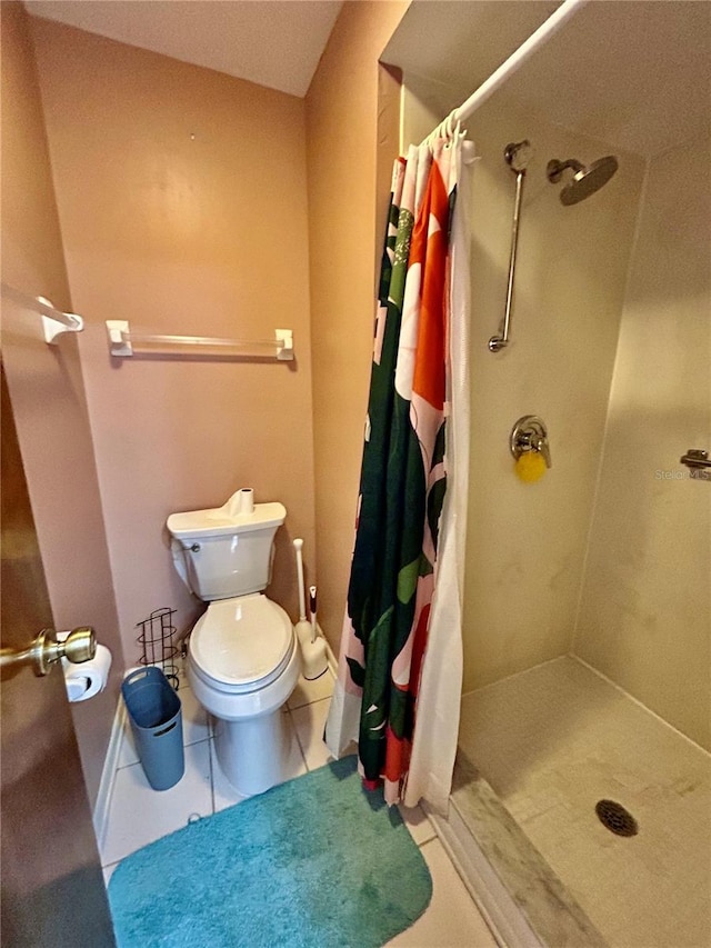 bathroom with tile patterned floors, toilet, and a shower with shower curtain