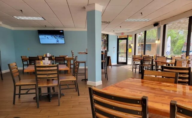 dining area with crown molding and light hardwood / wood-style flooring