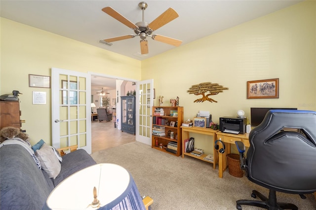 carpeted office space featuring french doors and ceiling fan