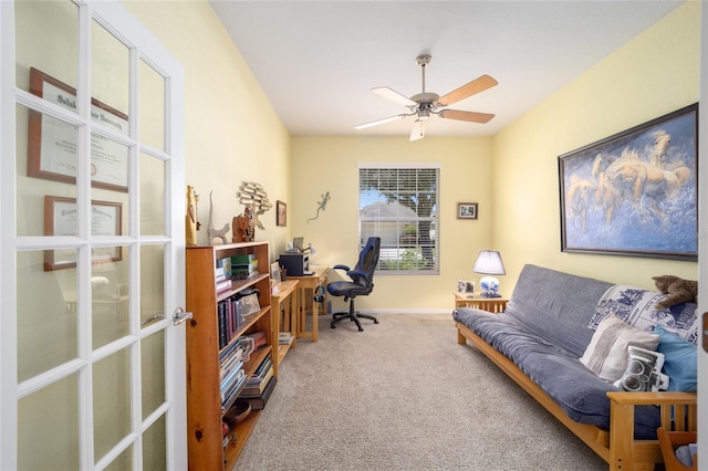 carpeted office featuring ceiling fan