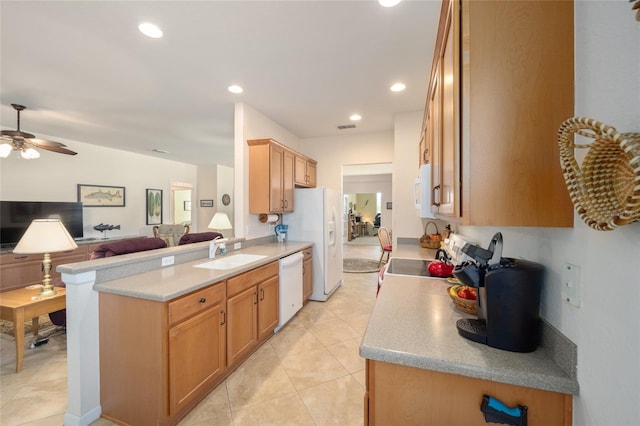 kitchen featuring white appliances, kitchen peninsula, light tile patterned floors, ceiling fan, and sink