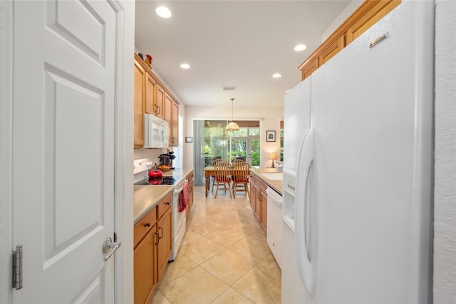 kitchen featuring pendant lighting, white appliances, and light tile patterned floors