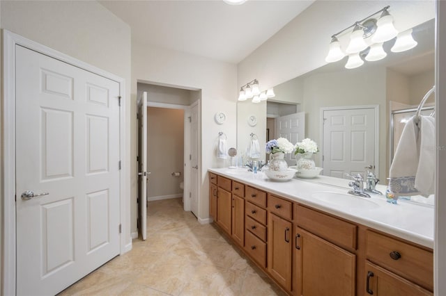 bathroom featuring vanity, toilet, and an enclosed shower