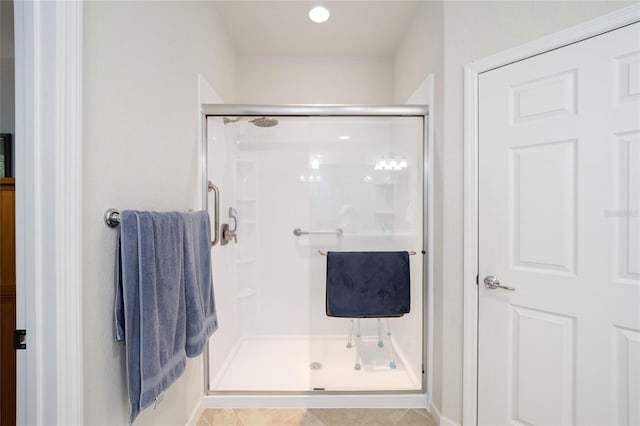 bathroom featuring tile patterned floors and an enclosed shower