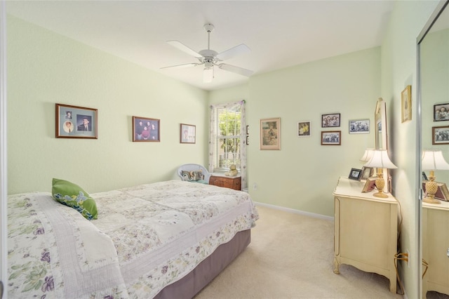 bedroom with ceiling fan and light colored carpet