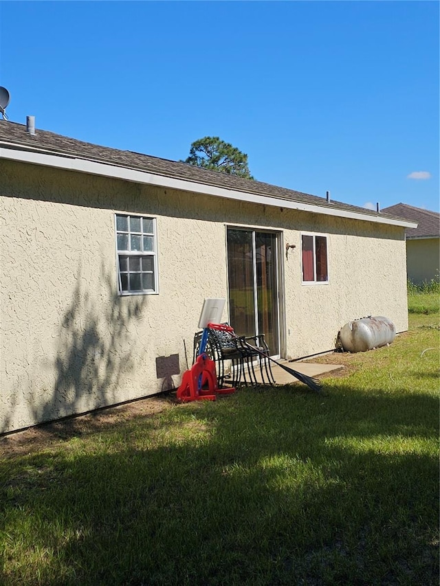 rear view of property with a yard