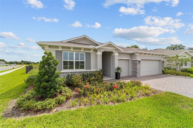 view of front facade with a garage and a front lawn