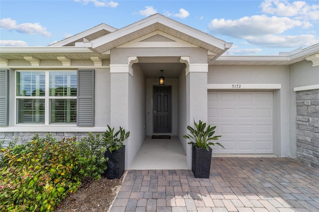 doorway to property with a garage