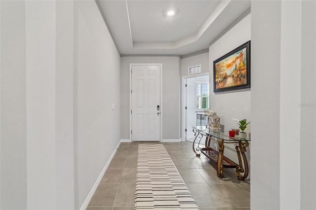 entryway with a raised ceiling