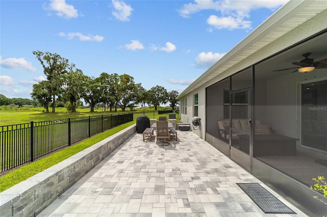 view of patio featuring a sunroom and ceiling fan