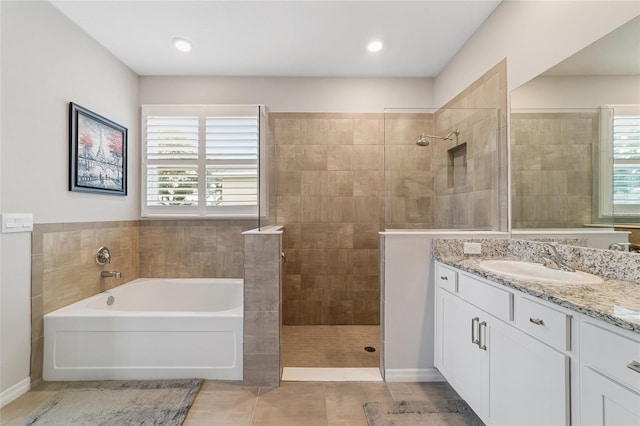 bathroom with tile patterned flooring, vanity, and independent shower and bath