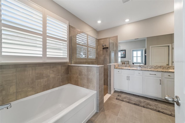 bathroom featuring tile patterned flooring, vanity, and separate shower and tub