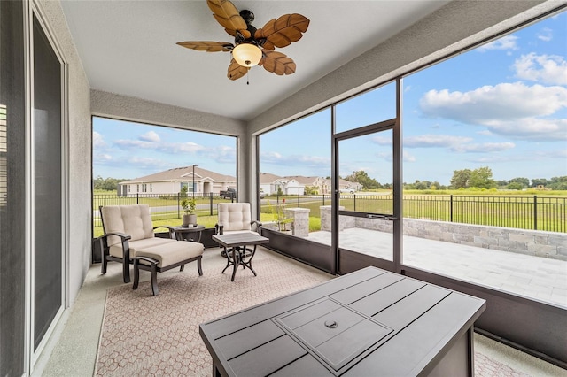 sunroom featuring a wealth of natural light and ceiling fan